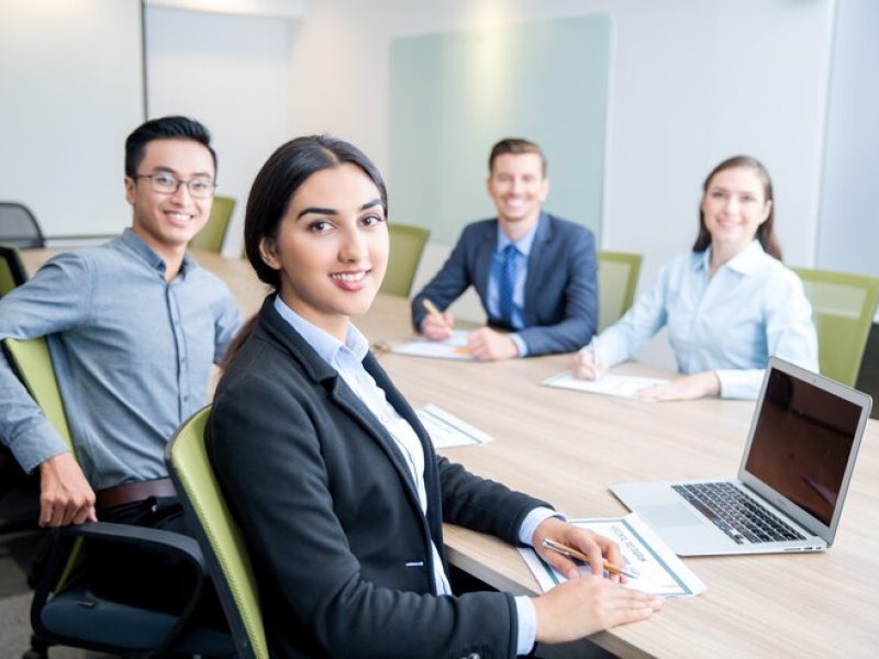 smiling-business-lady-working-with-colleagues_1262-2153